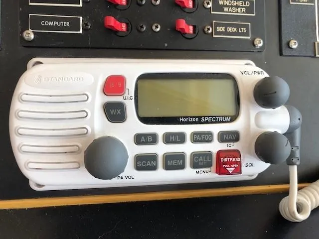 Slide: The Image of VHF marine radio on 1989 Custom Aluminum Pilothouse J Simpson boat dashboard. - 39