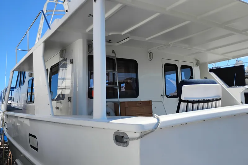 Slide: The Image of 1989 Custom Aluminum Pilothouse J Simpson boat with white exterior and spacious deck. - 4