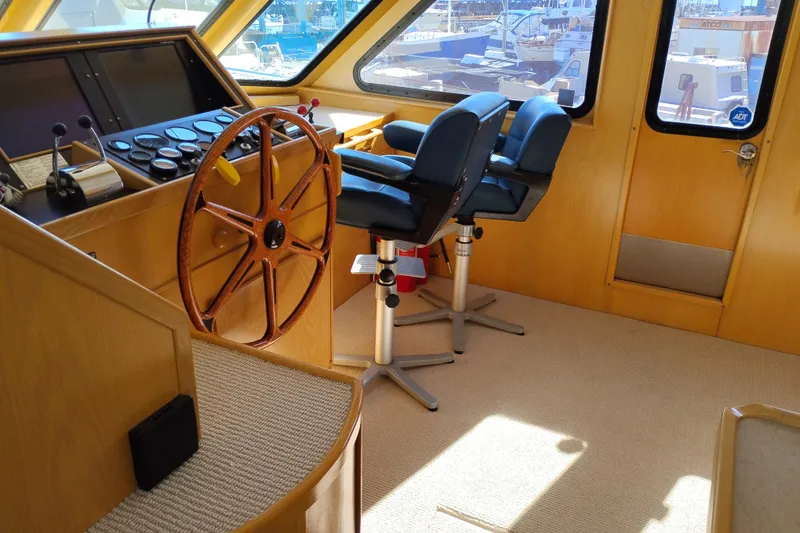 Slide: The Image of Pilothouse interior of 1989 Custom Aluminum Pilothouse J Simpson with steering wheel and control panel. - 41