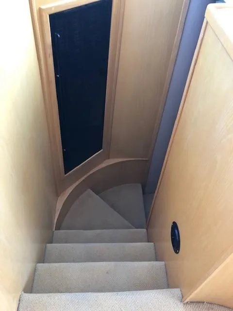 Slide: The Image of Staircase inside 1989 Custom Aluminum Pilothouse J Simpson, featuring wooden paneling and carpeted steps. - 42