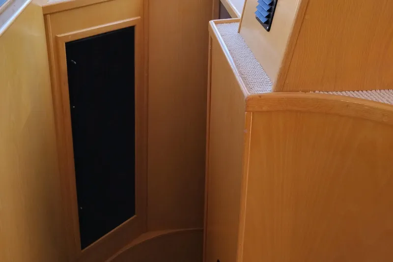 Slide: The Image of Interior of 1989 Custom Aluminum Pilothouse J Simpson, featuring wooden paneling and carpeted surfaces. - 43
