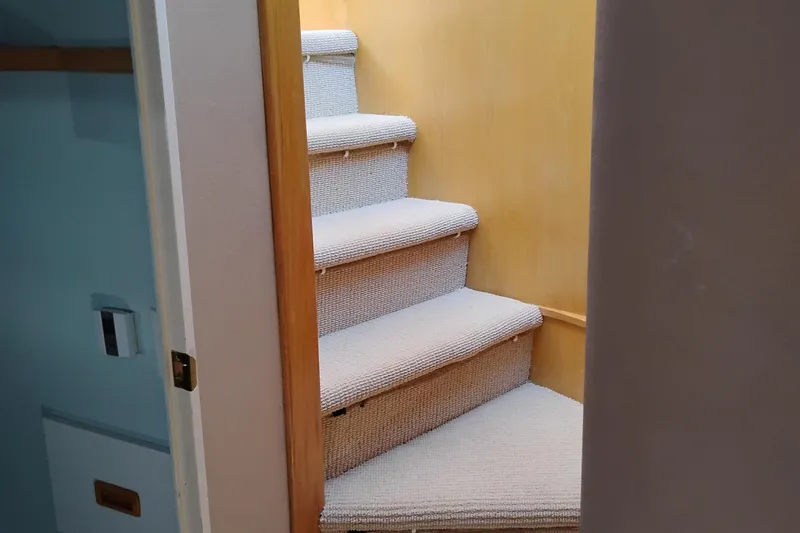 Slide: The Image of Carpeted stairs inside 1989 Custom Aluminum Pilothouse J Simpson boat. - 45