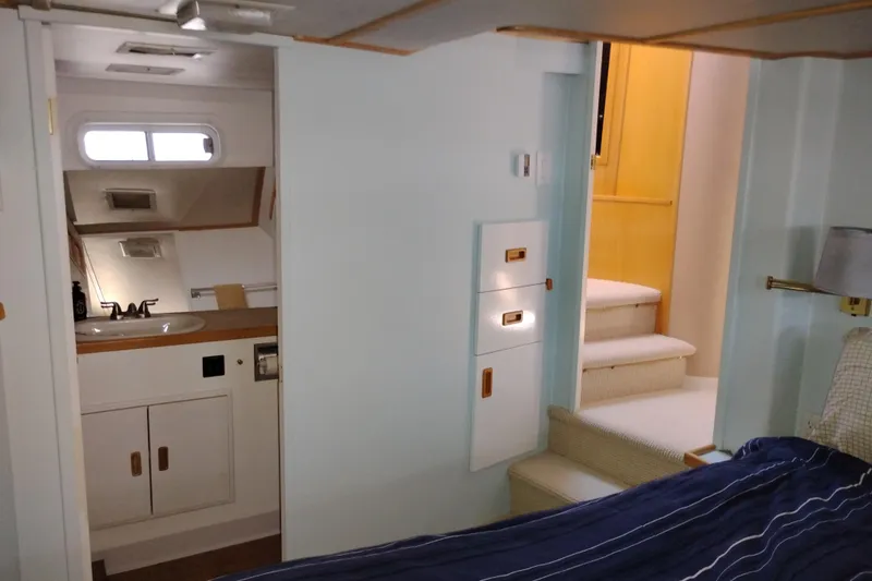 Slide: The Image of Interior of 1989 Custom Aluminum Pilothouse J Simpson, featuring a compact bathroom and cozy stairs. - 46