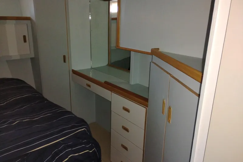 Slide: The Image of Interior of 1989 Custom Aluminum Pilothouse J Simpson with built-in cabinetry and bed. - 47