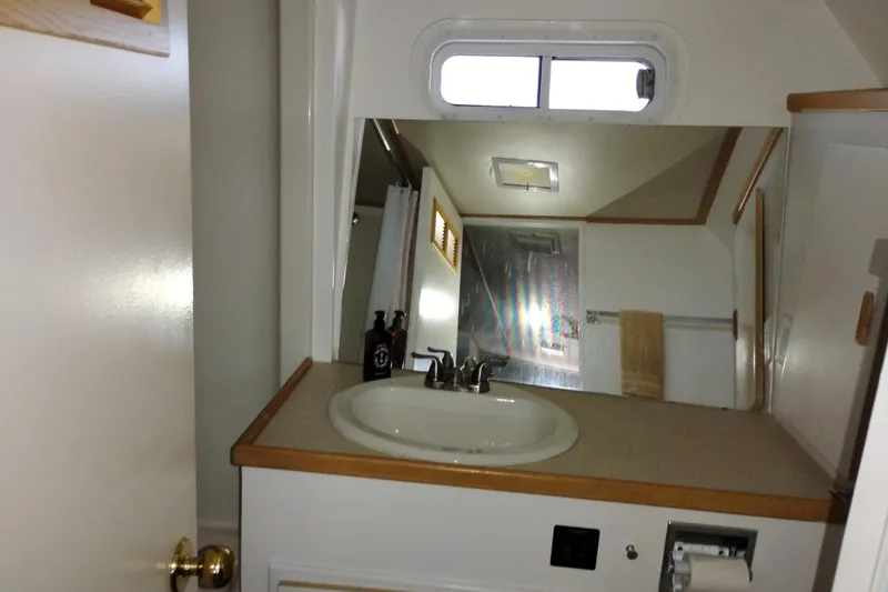 Slide: The Image of Bathroom interior of 1989 Custom Aluminum Pilothouse J Simpson with sink and mirror. - 48