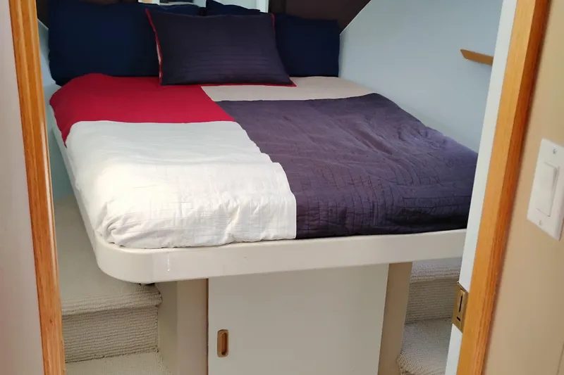 Slide: The Image of Cozy bedroom in 1989 Custom Aluminum Pilothouse J Simpson boat with colorful bedding. - 57