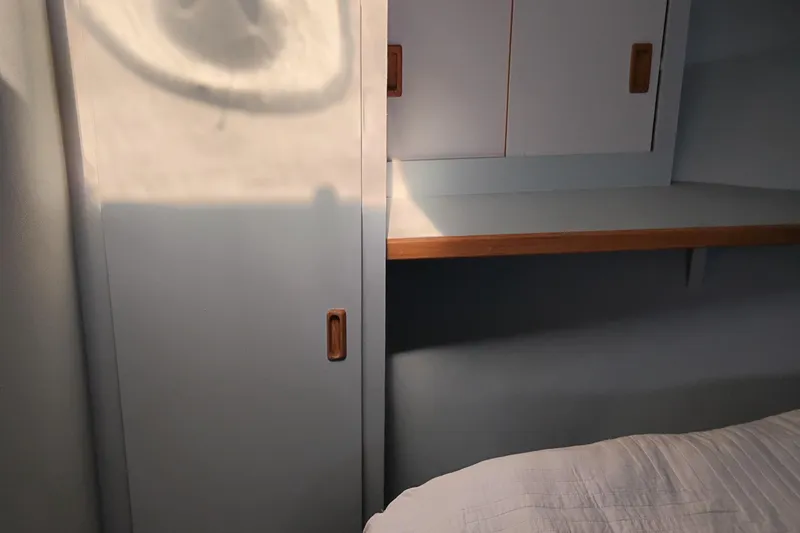 Slide: The Image of Interior of 1989 Custom Aluminum Pilothouse J Simpson with wooden accents and storage. - 58