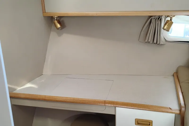 Slide: The Image of Interior of 1989 Custom Aluminum Pilothouse J Simpson with desk, lighting, and window. - 67