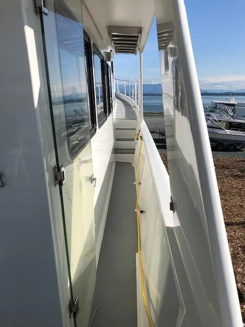 Slide: The Image of Side view of 1989 Custom Aluminum Pilothouse J Simpson boat with ocean backdrop. - 9