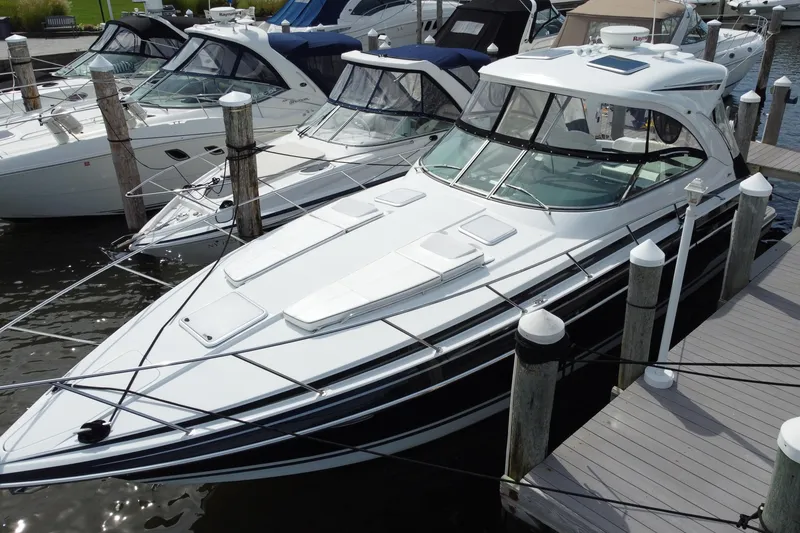 The Image of 2015 Formula 37 Performance Cruiser docked at marina, sleek design, white exterior. - 0