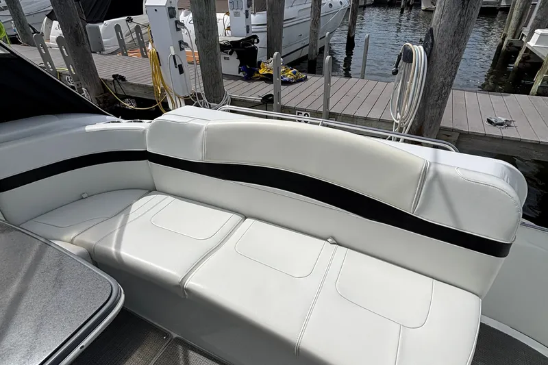 Slide: The Image of 2015 Formula 37 Performance Cruiser with white seating at a marina dock. - 14