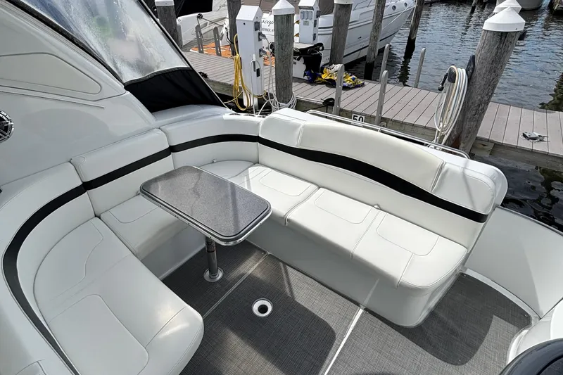 Slide: The Image of 2015 Formula 37 Performance Cruiser interior with white seating and table at marina. - 15