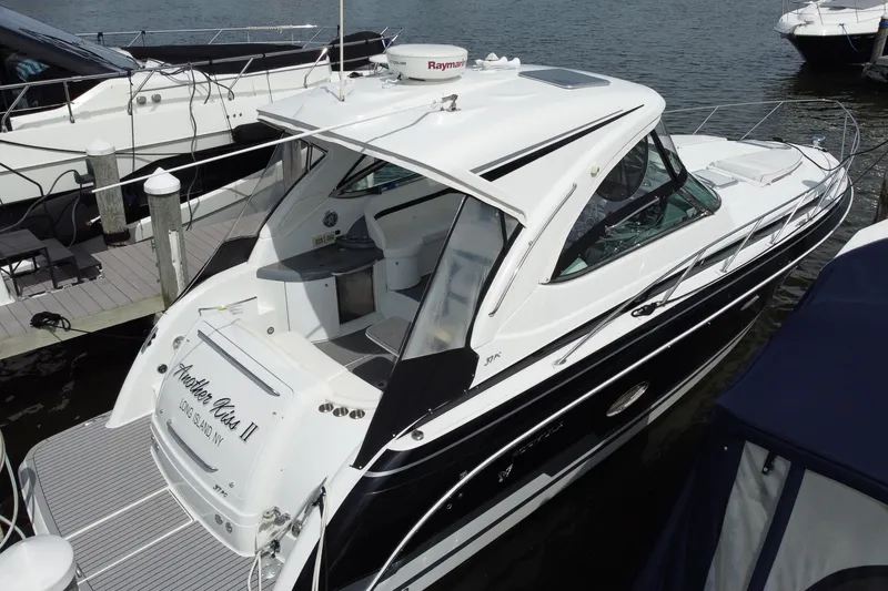 Slide: The Image of 2015 Formula 37 Performance Cruiser docked, featuring sleek design and spacious deck. - 2