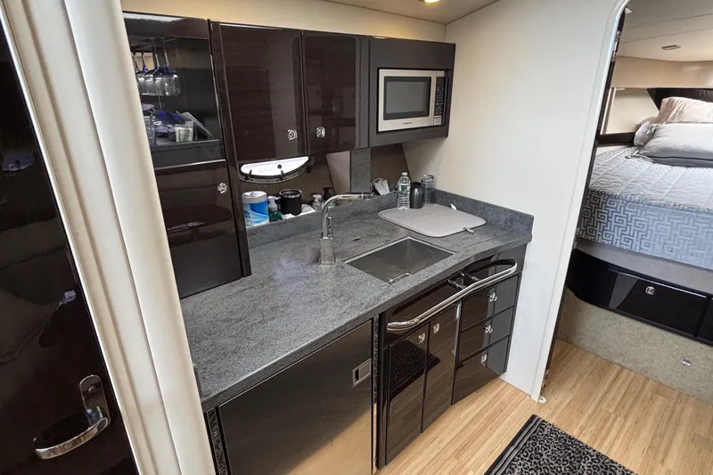 Slide: The Image of 2015 Formula 37 Performance Cruiser interior with modern kitchenette and cozy bedroom. - 34