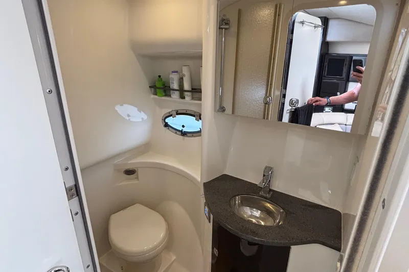 Slide: The Image of 2015 Formula 37 Performance Cruiser bathroom with sink, toilet, and porthole window. - 40