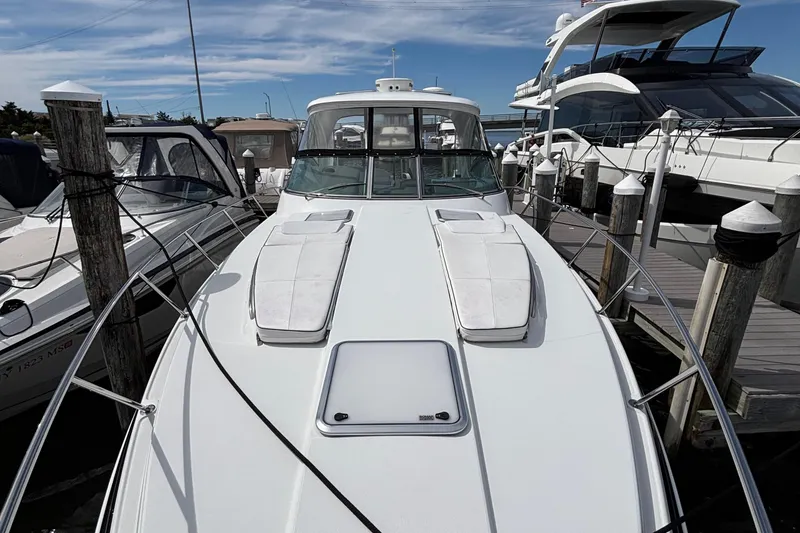 Slide: The Image of 2015 Formula 37 Performance Cruiser docked at marina, surrounded by other boats. - 42