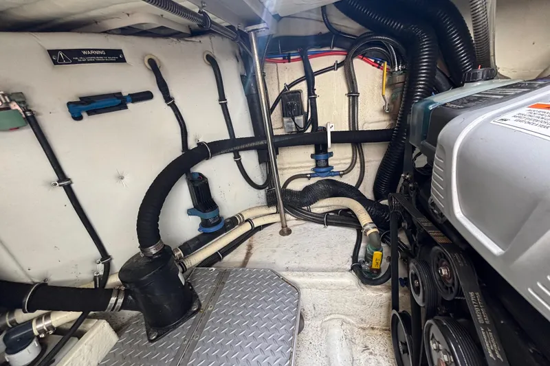 Slide: The Image of Engine room of a 2015 Formula 37 Performance Cruiser with visible hoses and machinery. - 57