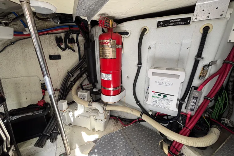 Slide: The Image of Engine room of 2015 Formula 37 Performance Cruiser with fire extinguisher and electrical components. - 58