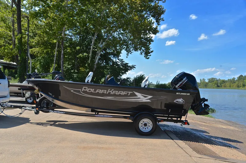 Slide: The Image of 2024 Polar Kraft 165 boat on trailer by a lake, under clear blue sky. - 11