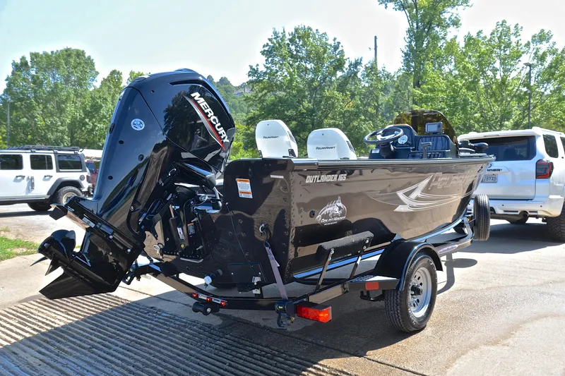 Slide: The Image of 2024 Polar Kraft 165 boat with Mercury outboard motor on trailer, parked outdoors. - 14