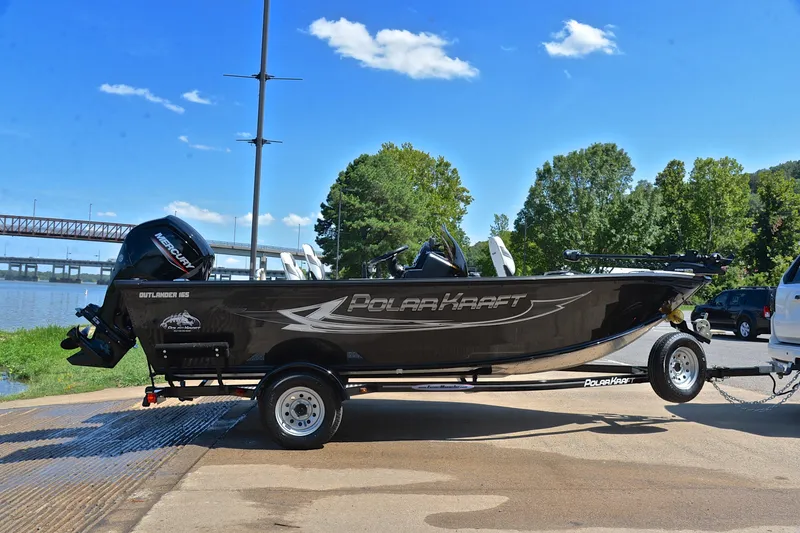 Slide: The Image of 2024 Polar Kraft 165 boat on trailer by a river, sunny day. - 15