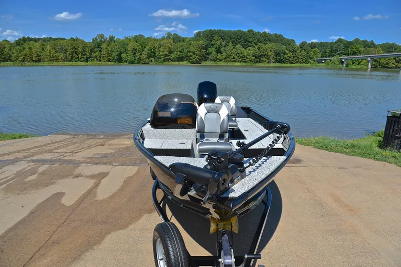 Slide: The Image of 2024 Polar Kraft 165 boat on trailer by a scenic lake. - 17