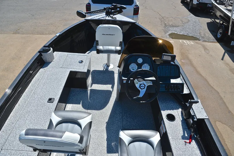 Slide: The Image of 2024 Polar Kraft 165 boat interior with steering console, seating, and fishing equipment. - 18