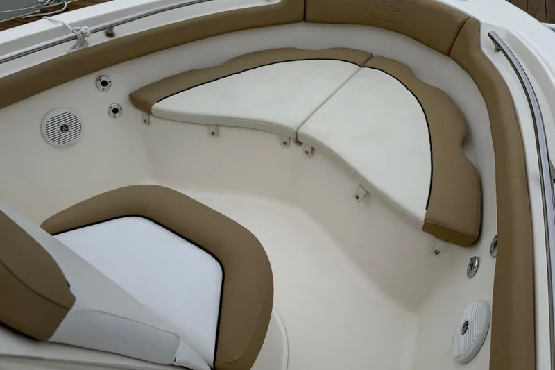 Slide: The Image of 2016 Pioneer 197 Islander boat interior with cushioned seating and stainless steel railings. - 10