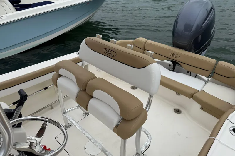 Slide: The Image of 2016 Pioneer 197 Islander boat with Yamaha 150 engine, parked outdoors. - 11