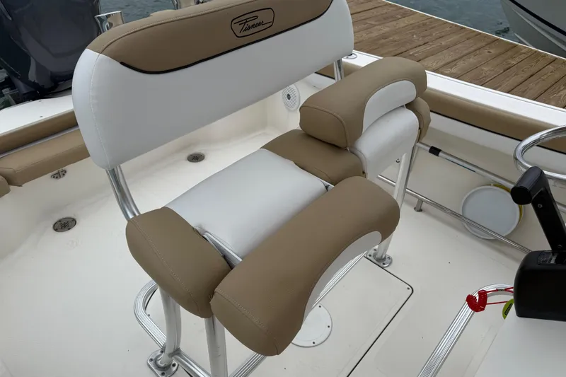 Slide: The Image of 2016 Pioneer 197 Islander boat interior with tan and white cushioned seating. - 13