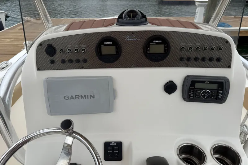 Slide: The Image of 2016 Pioneer 197 Islander boat seating with tan and white upholstery. - 15