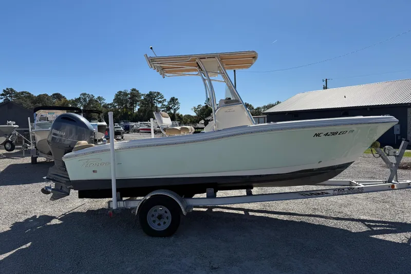 Slide: The Image of 2016 Pioneer 197 Islander boat on trailer, parked outdoors under clear sky. - 27