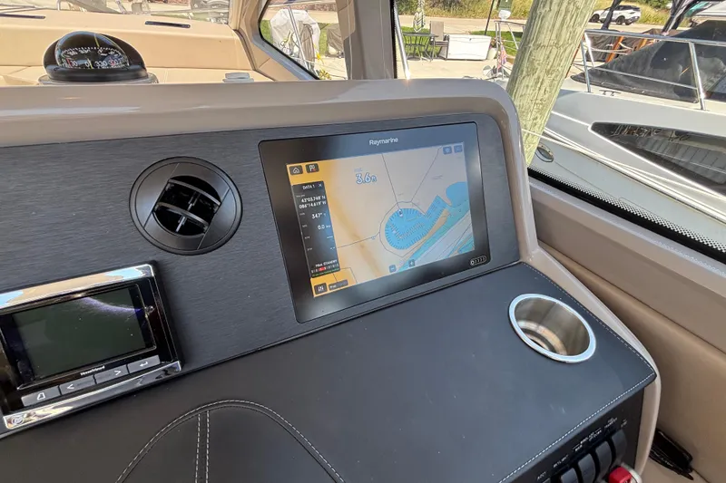 Slide: The Image of 2018 Sea Ray Sundancer 460 helm with navigation display and control panel. - 20