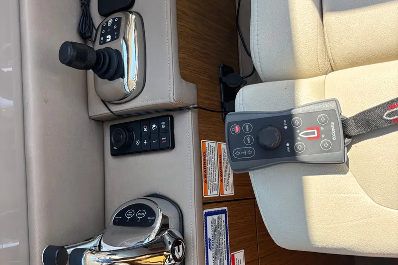 Slide: The Image of 2018 Sea Ray Sundancer 460 yacht controls with joystick and navigation panel. - 22