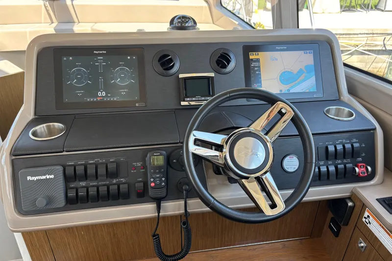 Slide: The Image of Helm of 2018 Sea Ray Sundancer 460 with Raymarine navigation displays and controls. - 24