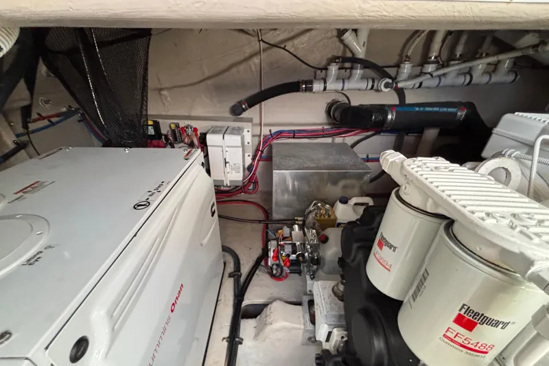 Slide: The Image of Engine room of 2018 Sea Ray Sundancer 460, featuring Cummins Onan generator and Fleetguard filters. - 49