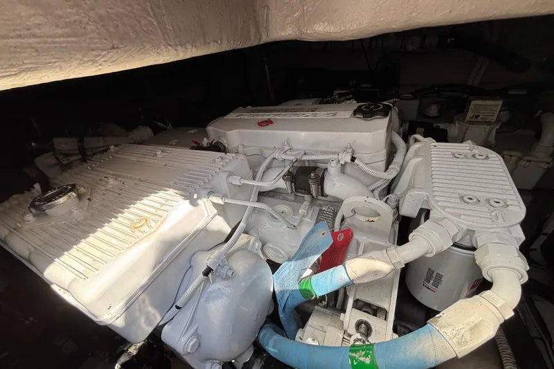 Slide: The Image of Engine compartment of a 2018 Sea Ray Sundancer 460, showcasing detailed mechanical components. - 52