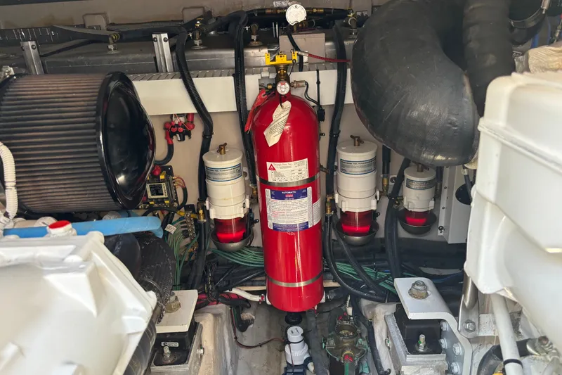 Slide: The Image of Engine room of 2018 Sea Ray Sundancer 460 with fire extinguisher and filters. - 54