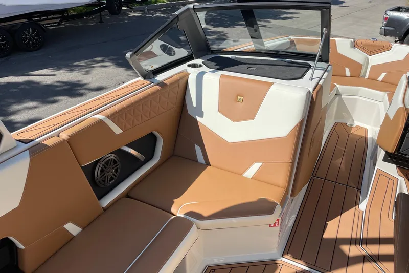 Slide: The Image of 2026 Nautique Super Air Nautique GS22 interior with tan and white seating. - 10