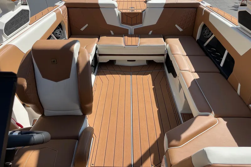 Slide: The Image of 2026 Nautique Super Air Nautique GS22 interior with tan and white seating, spacious layout. - 12