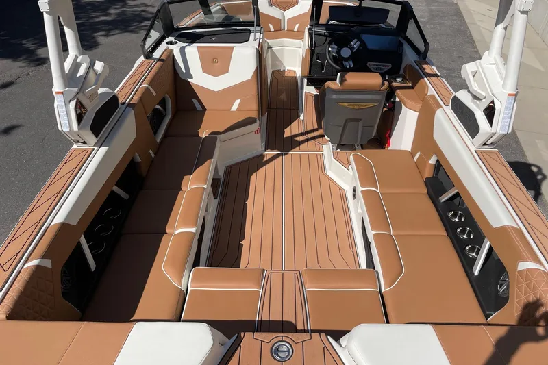 Slide: The Image of 2026 Nautique Super Air Nautique GS22 interior with tan and white seating, sleek design. - 5