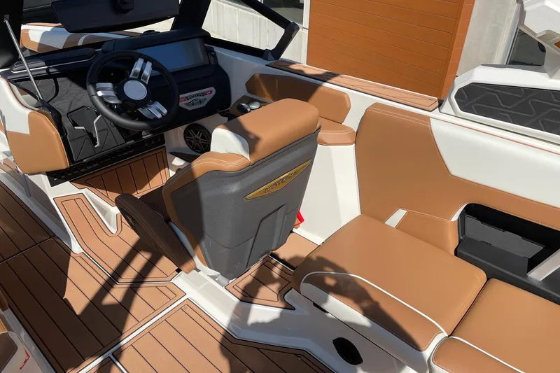 Slide: The Image of 2026 Nautique Super Air Nautique GS22 interior with tan and white seating, modern dashboard. - 6