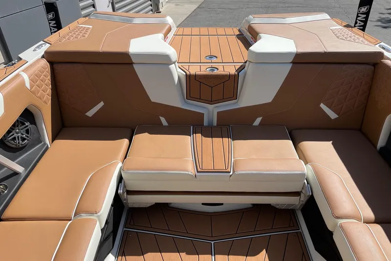 Slide: The Image of 2026 Nautique Super Air Nautique GS22 interior with tan and white seating. - 8