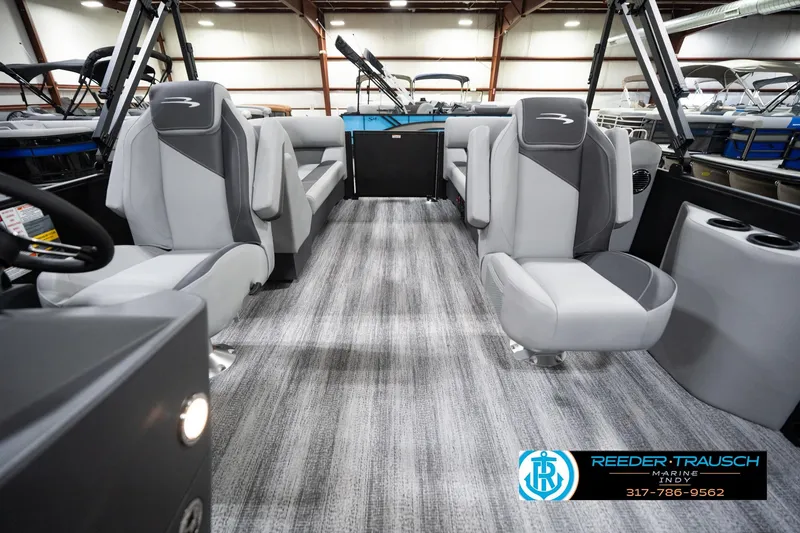 Slide: The Image of 2026 Bennington 23 SSR boat interior with gray seating and modern design in showroom. - 16