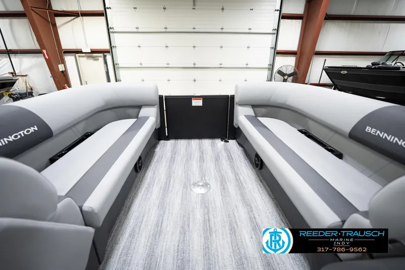 Slide: The Image of 2026 Bennington 23 SSR pontoon boat interior with gray seating in a showroom. - 21