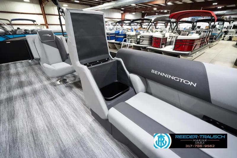 Slide: The Image of 2026 Bennington 23 SSR pontoon boat interior with open storage compartment in showroom. - 24