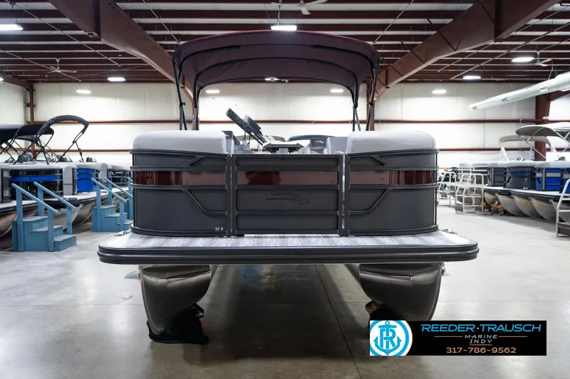 Slide: The Image of 2026 Bennington 23 SSR pontoon boat in showroom, front view, under indoor lighting. - 4