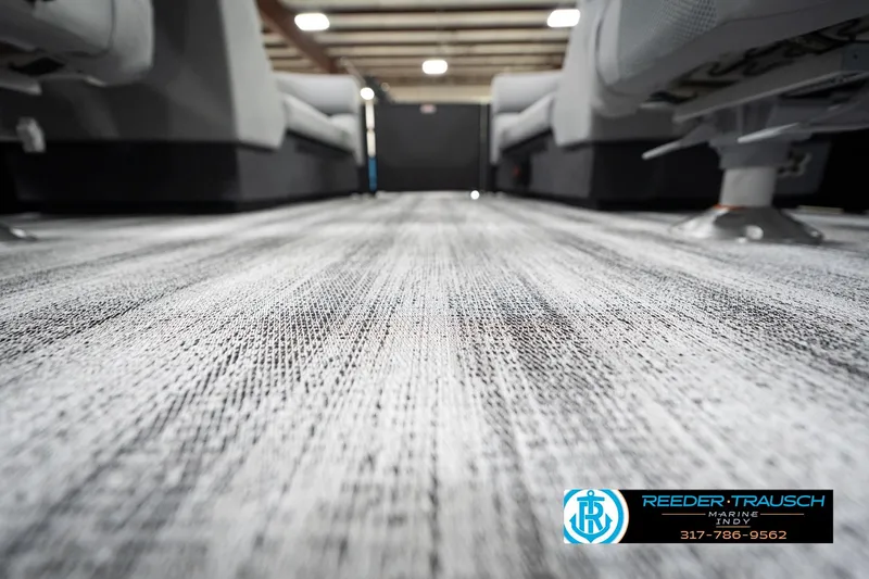 Slide: The Image of 2026 Bennington 23 SSR boat interior with textured flooring, showcasing seating and modern design. - 45