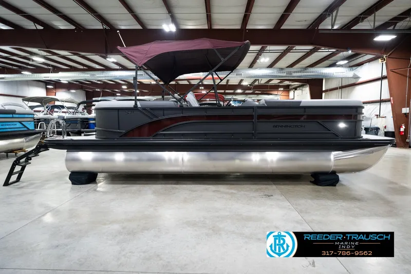 Slide: The Image of 2026 Bennington 23 SSR pontoon boat in showroom with maroon canopy. - 6