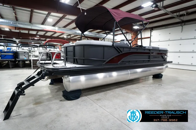 Slide: The Image of 2026 Bennington 23 SSR pontoon boat in showroom with maroon canopy. - 7